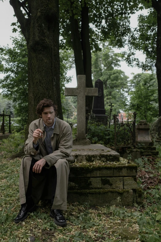 a man sitting on a bench in a cemetery, an album cover, by Adriaen Hanneman, unsplash, renaissance, joe keery, detective, cast, ( ( theatrical ) )