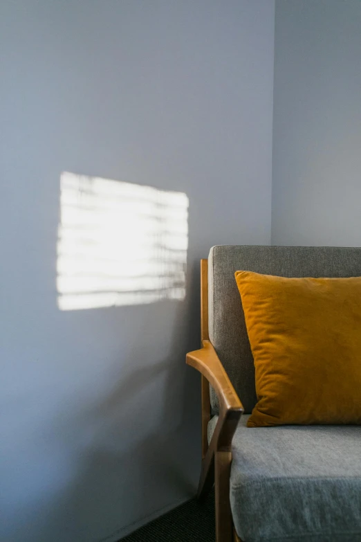 a chair sitting next to a window in a room, light and space, sunlight filtering through skin, gray and orange colours, uplit, best shadow quality