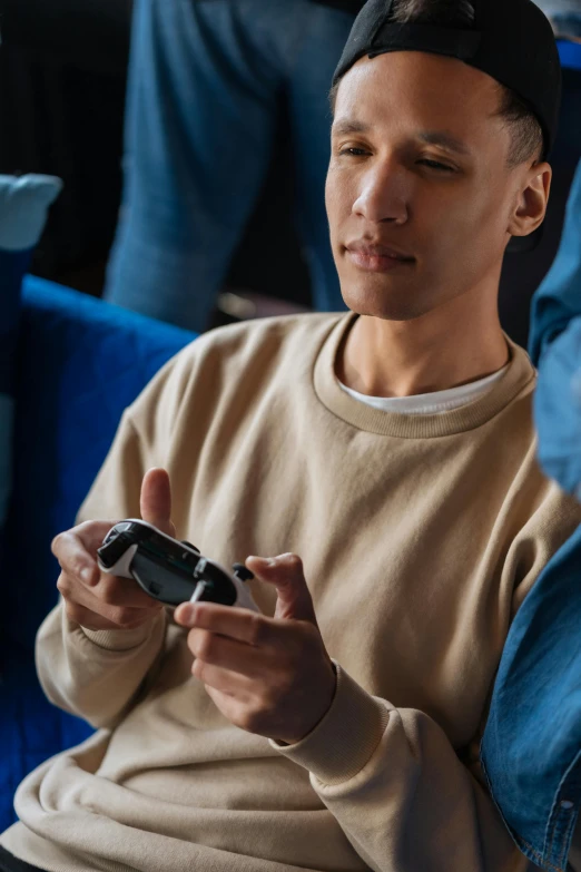 a man sitting next to a woman holding a cell phone, playstation 5, holding controller, shot with sony alpha 1 camera, nvidia promotional image