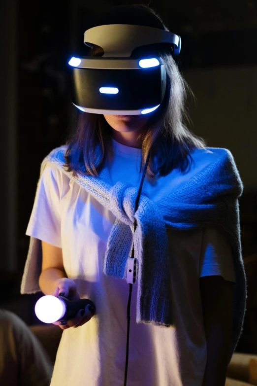 a woman in a white shirt wearing a virtual reality headset, holding a glowing orb, playstation 6, blindfolded, brown