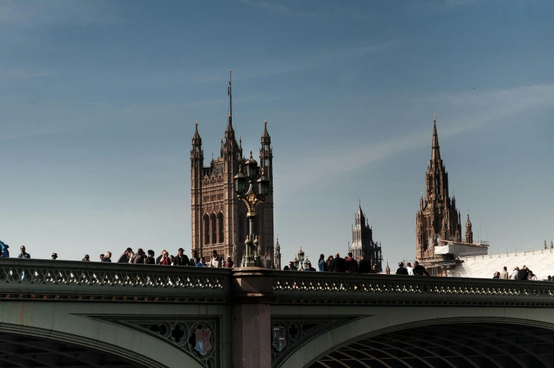 a group of people standing on top of a bridge, by Joseph Severn, pexels contest winner, renaissance, houses of parliament, slide show, asymmetrical spires, zoomed out to show entire image