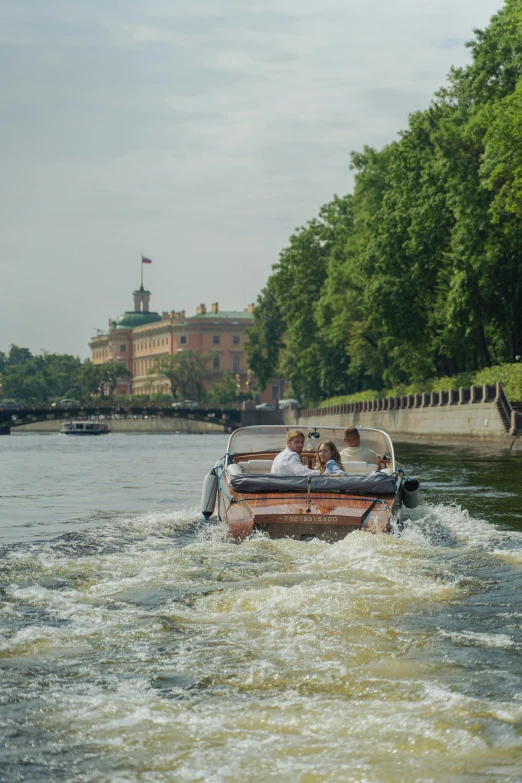 a group of people riding on the back of a boat, inspired by Vasily Surikov, pexels contest winner, danube school, lush surroundings, warsaw, exterior view, in summer