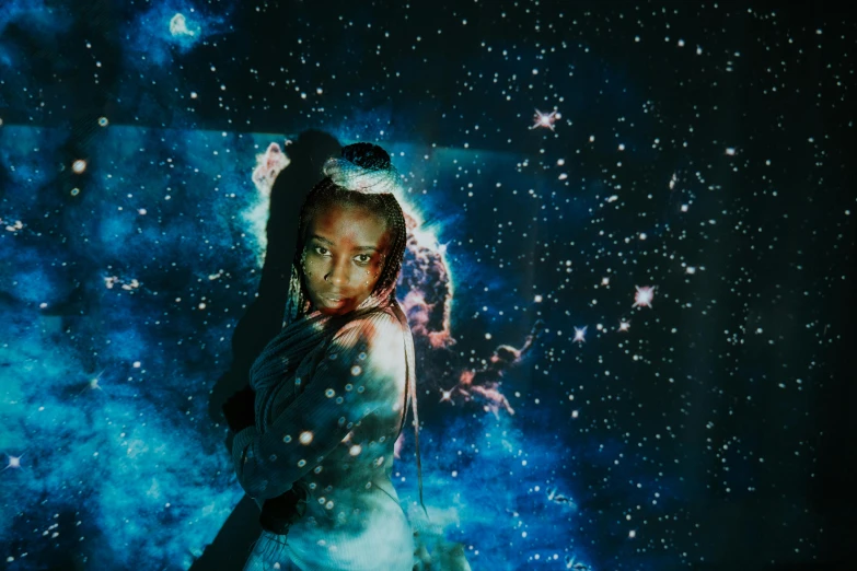 a woman standing in front of a star filled sky, an album cover, unsplash, afrofuturism, galaxy themed room, with a black background, ☁🌪🌙👩🏾, embracing