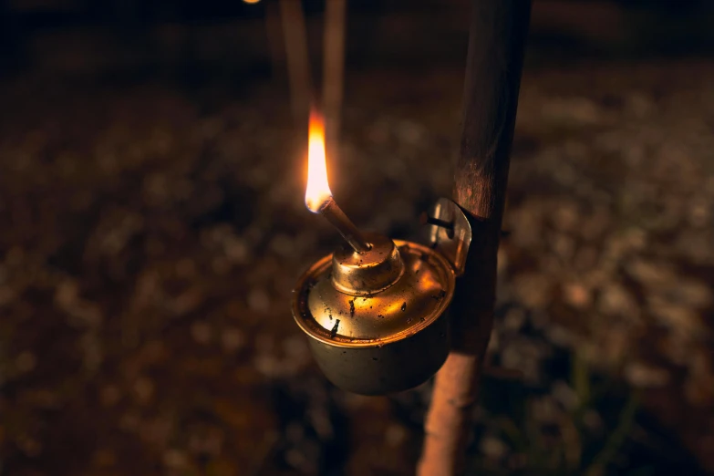 a close up of a lit candle on a stick, by Eglon van der Neer, warm lantern lighting, rusty, moonshine cybin, medium-shot