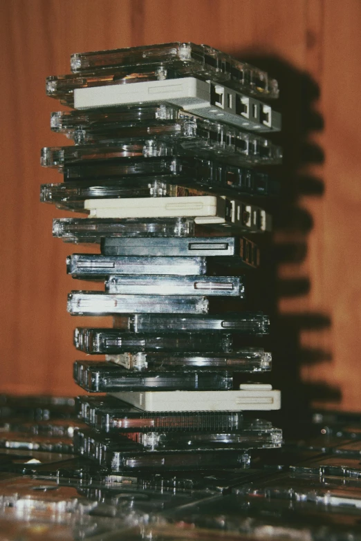 a stack of cds sitting on top of a table, inspired by Elsa Bleda, kinetic art, cassette, ignant, medium close - up ( mcu ), tower