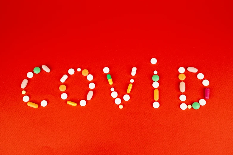 the word drug spelled out of pills on a red background, by Olivia Peguero, pexels, graffiti, poster of corona virus, covid, holiday, covered in