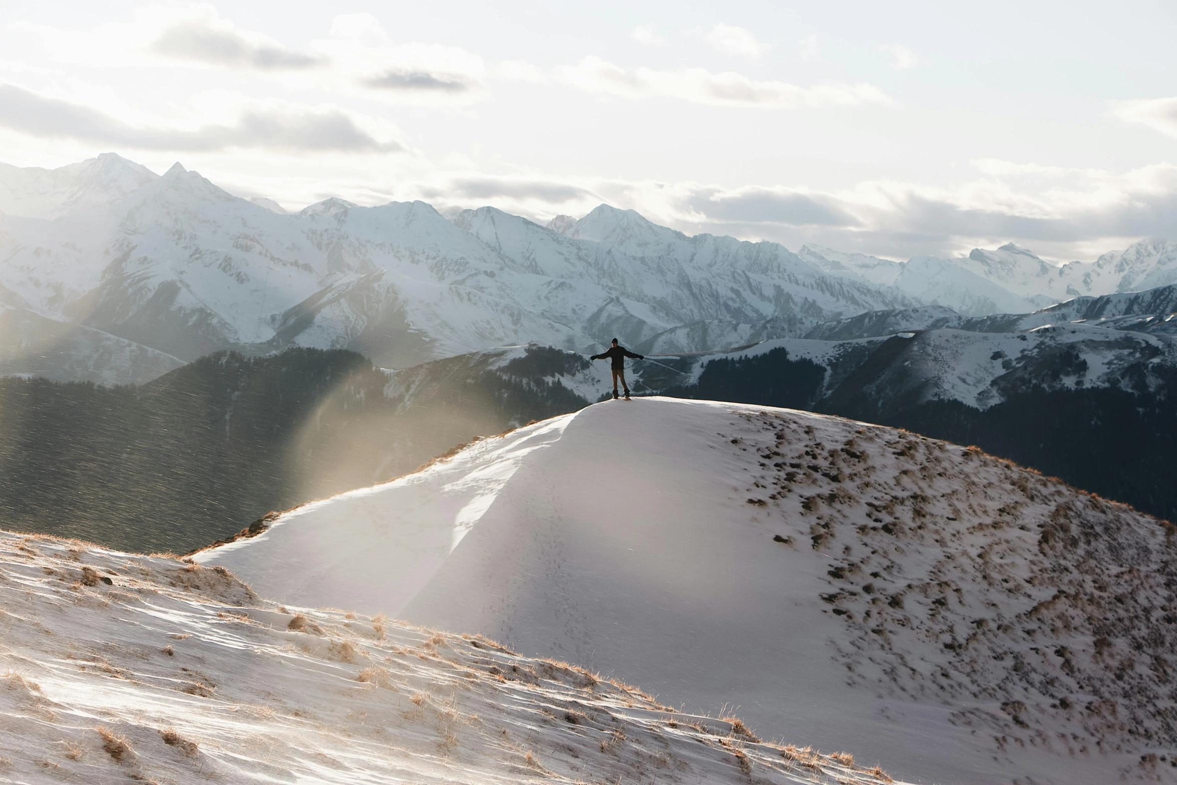 a person standing on top of a snow covered mountain, by Peter Churcher, unsplash contest winner, new zeeland, dune, soft skin, alpes