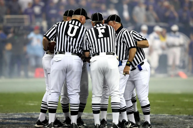 a group of men standing next to each other on a field, by Dan Frazier, shutterstock, interrupting the big game, a purple and white dress uniform, ap news photograph, striped