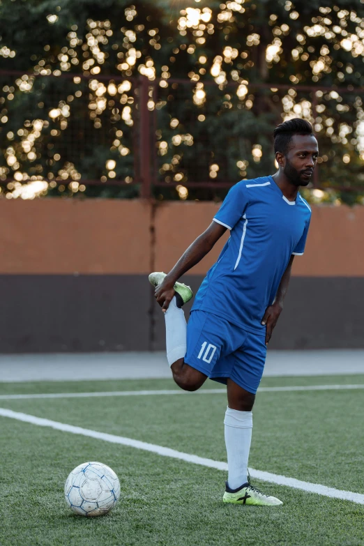 a young man kicking a soccer ball on a field, pexels contest winner, renaissance, somalia, thinking pose, promo image, thumbnail