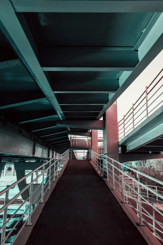 a long bridge over a body of water, inspired by Elsa Bleda, brutalism, teal silver red, urban exploring, high contrast 8k, escalators