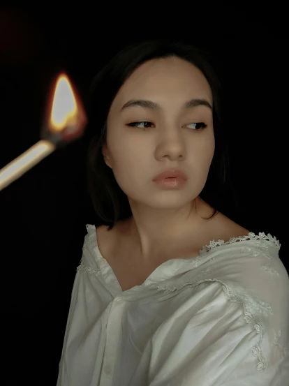 a woman in a white dress holding a lit candle, an album cover, inspired by irakli nadar, pexels contest winner, renaissance, 🤤 girl portrait, 4 k asymmetrical portrait, asian woman, gif