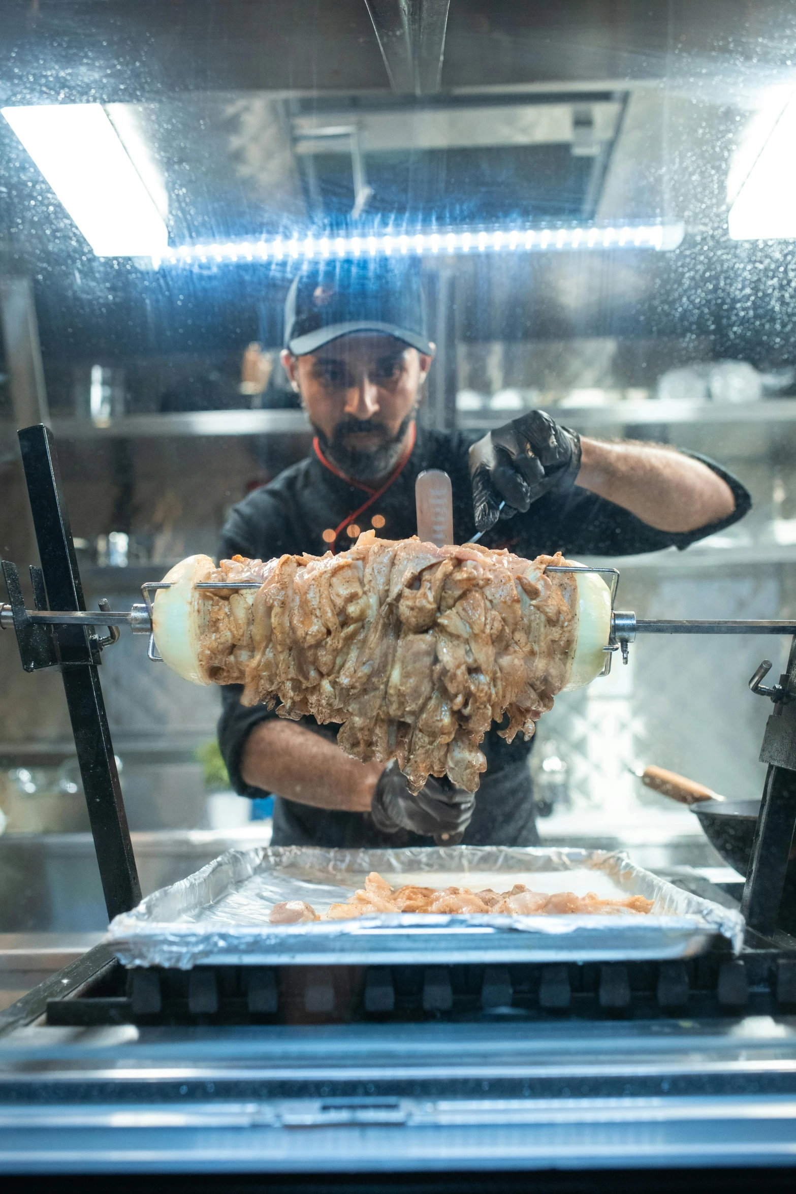 a man preparing food in a commercial kitchen, kebab, 2019 trending photo, thumbnail, fully symmetrical