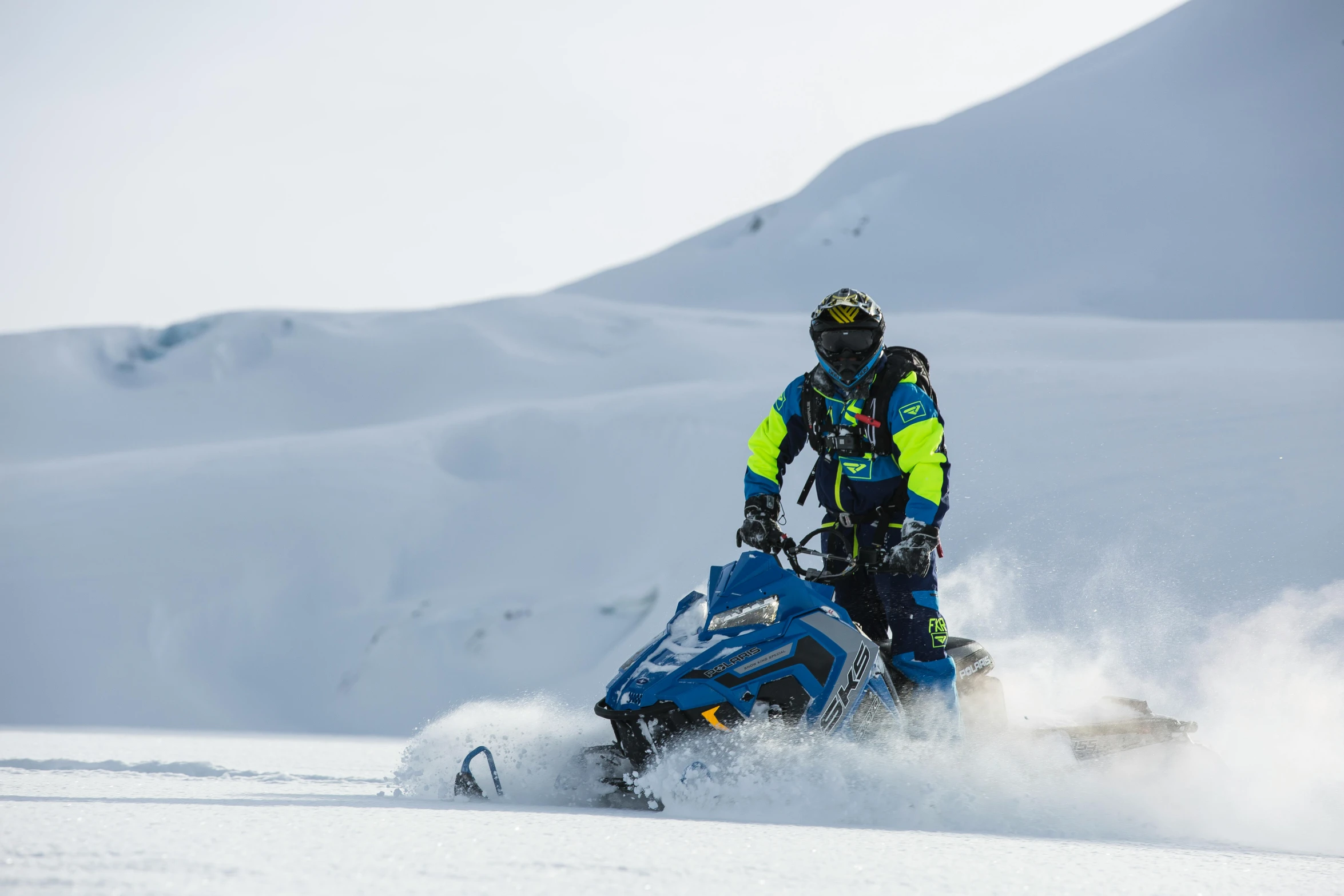 a person riding a snowmobile in the snow, pexels contest winner, hurufiyya, blue and yellow color theme, profile image, iceland photography, pbr