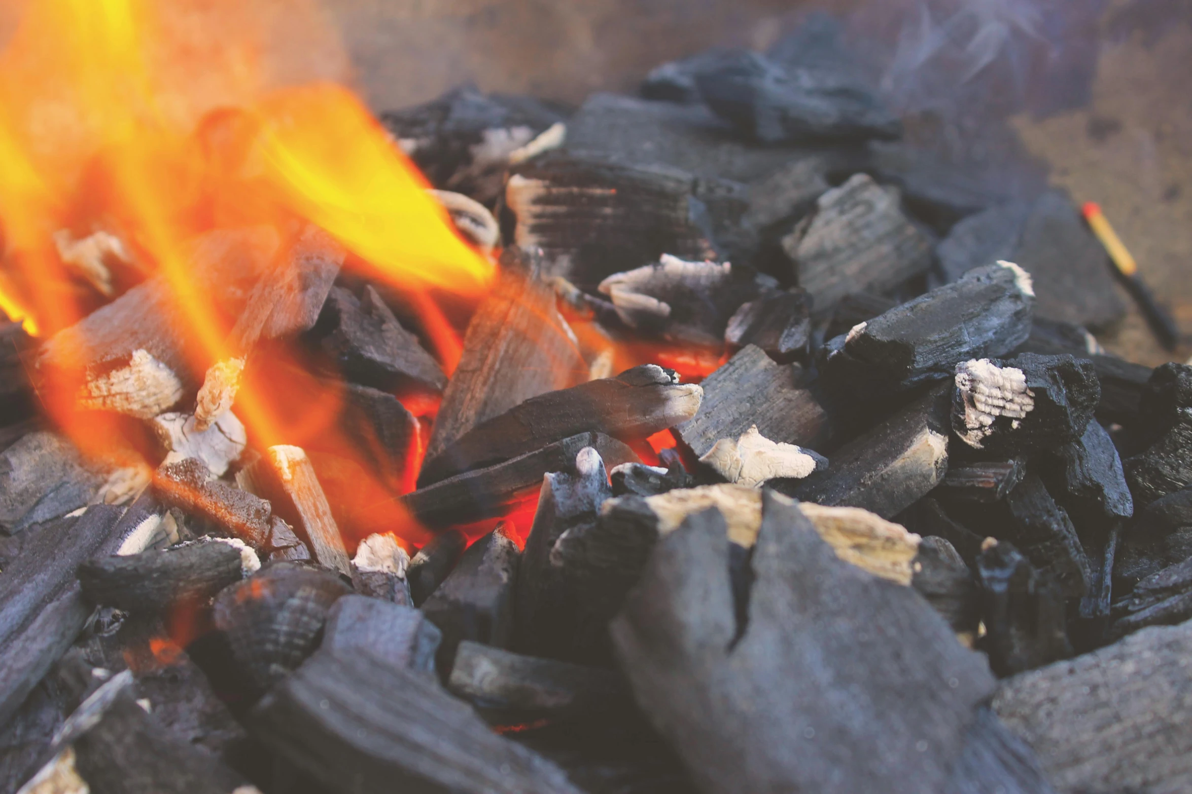 a pile of charcoal sitting on top of a fire, pexels contest winner, geforce rtx 3090 on fire, al fresco, warm coloured, birdseye view