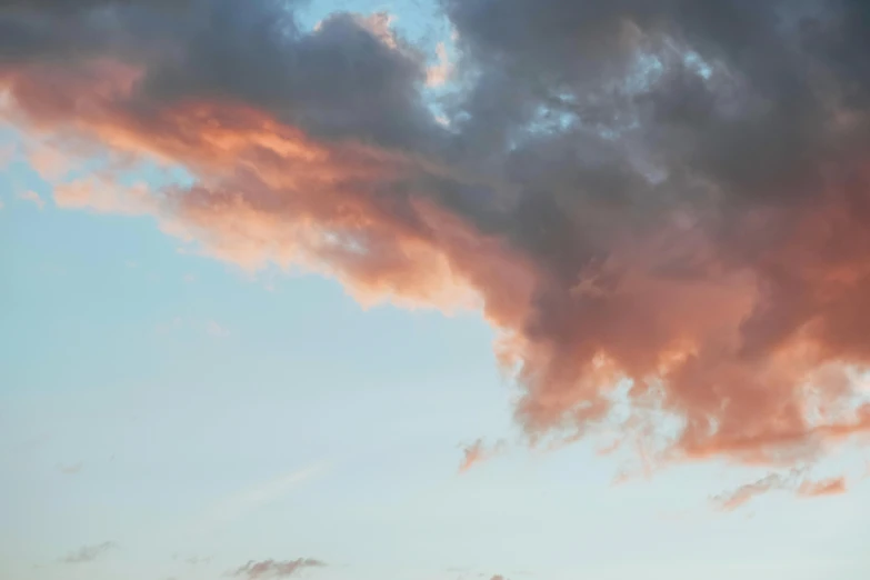 a couple of cows standing on top of a lush green field, a picture, unsplash, romanticism, dramatic pink clouds, ominous red cumulonimbus clouds, a dragon made of clouds, sunset photo at golden hour