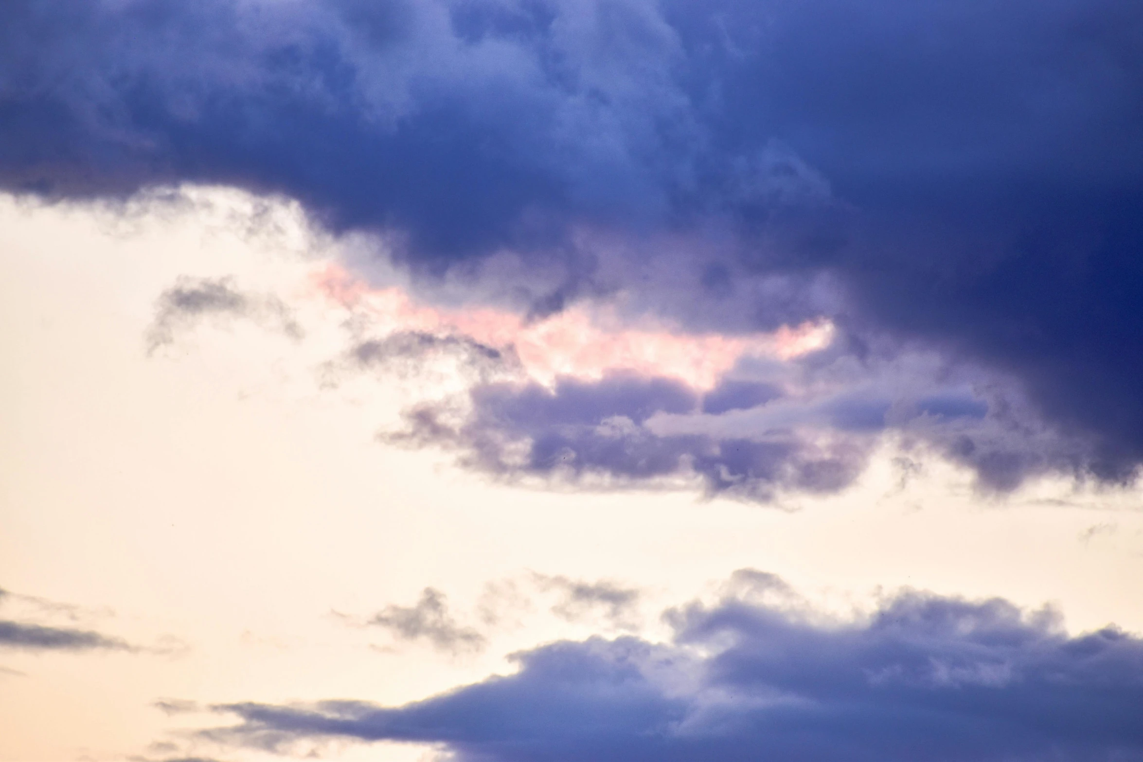 there is a plane that is flying in the sky, by Carey Morris, unsplash, romanticism, soft lilac skies, evening storm, close - up photograph, blue and pink shift