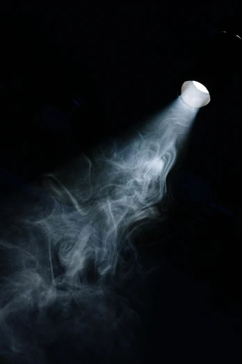 a person holding a tennis racquet with smoke coming out of it, by David Donaldson, light and space, ceiling hides in the dark, ((mist)), light cone, made of mist