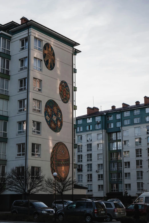 a building with a clock on the side of it, an album cover, by Sven Erixson, unsplash, socialist realism, medallions, residential area, decorated with russian motifs, circular towers