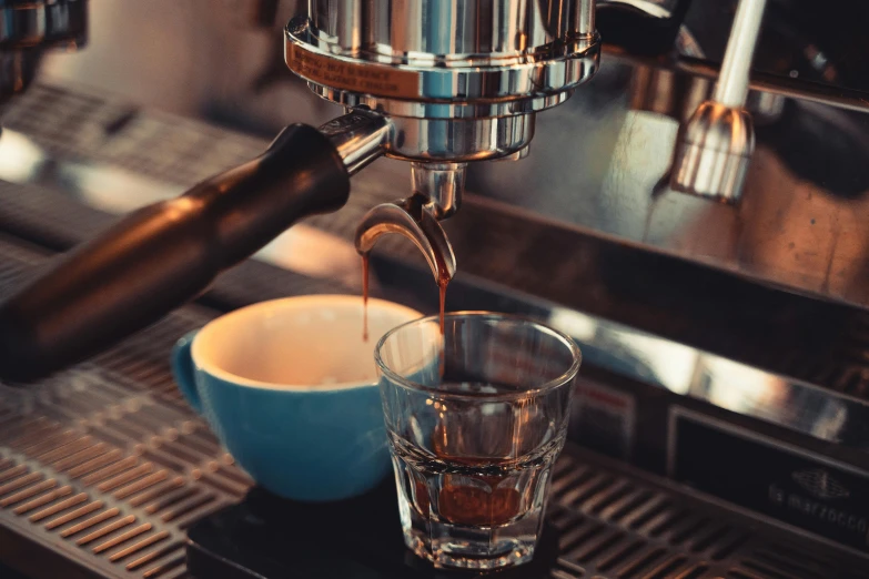 a cup of coffee being poured into a glass, by Niko Henrichon, pexels contest winner, espresso machine, manuka, high quality screenshot, multiple stories