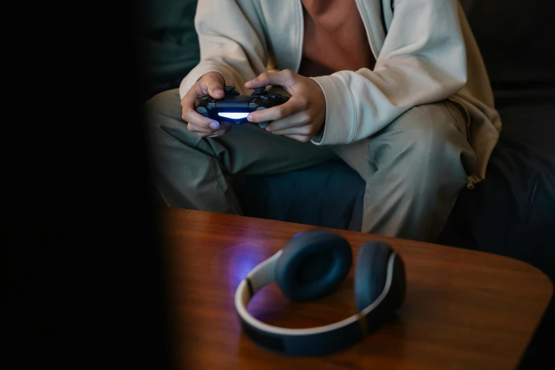 a man sitting on a couch while holding a wii game controller