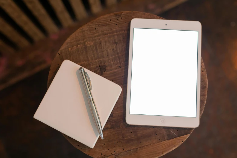 a tablet computer sitting on top of a wooden table, by Carey Morris, pixabay, square, whiteboards, creamy, an elegant