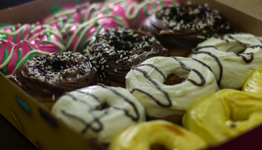 a box of assorted donuts sitting on a table, by Lee Loughridge, pexels, hurufiyya, closeup at the food, kek, chocolate, profile photo