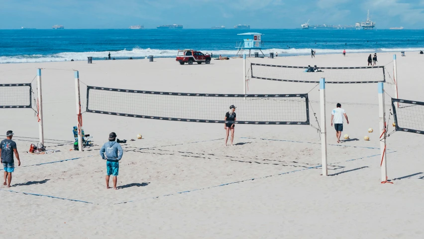 a group of people playing volleyball on a beach, square, unsplash 4k, los angeles ca, 🚿🗝📝