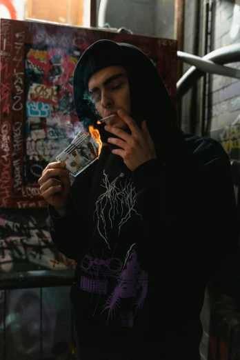 a man in a hoodie smokes a cigarette, an album cover, unsplash, low purple flame, federation clothing, highly upvoted, street wears
