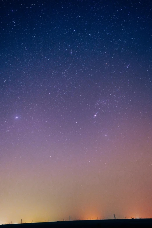 a sky filled with lots of stars next to a field, by Doug Ohlson, minimalism, soft purple glow, sirius a and sirius b, medium closeup, 2263539546]