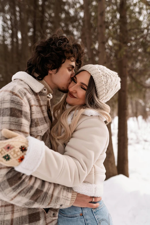 a man and a woman kissing in the snow, a colorized photo, trending on pexels, curls, brown, cozy aesthetic, quebec