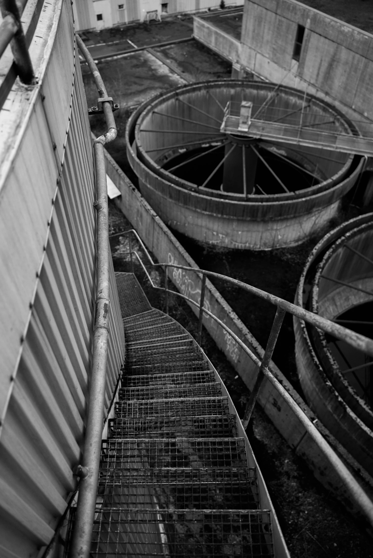 a man riding a skateboard on top of a ramp, a black and white photo, inspired by André Kertész, process art, sewer pipe entrance, watertank, 8k 50mm iso 10, stairs