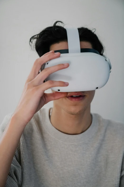 a man wearing a virtual reality headset, by Robbie Trevino, trending on pexels, hypermodernism, teenage boy, asian male, front facing shot, 2020 video game screenshot