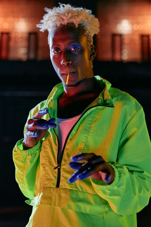 a close up of a person holding a cell phone, inspired by Ed Paschke, pexels, afrofuturism, model wears a puffer jacket, glow sticks, lance reddick, ( ( theatrical ) )