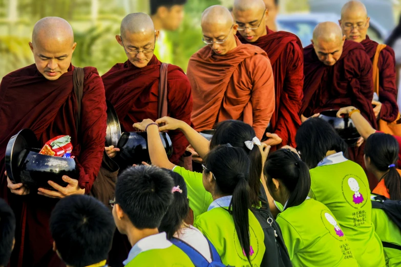 a group of people standing next to each other, by Dan Content, pexels contest winner, monk clothes, signing autographs, game, green robes