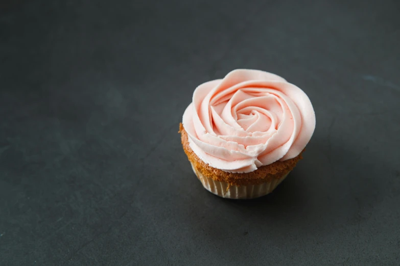 a cupcake with pink frosting on a black surface, pexels, renaissance, background image, natural point rose', miniatures