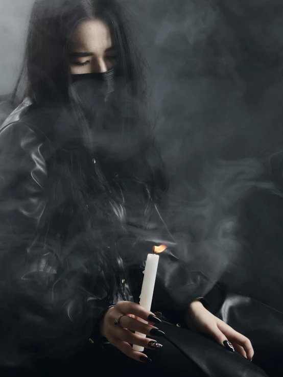 a woman in a black leather jacket holding a lit candle, an album cover, inspired by Elsa Bleda, trending on unsplash, surrealism, smoke and fog, portrait of sadako of the ring, ☁🌪🌙👩🏾, photograph of a techwear woman