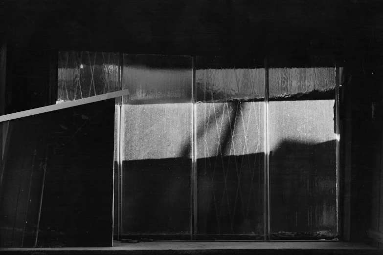 a black and white photo of a window, a black and white photo, by Maurycy Gottlieb, conceptual art, glass wall, 1957, lights and shadows, tsuyoshi nagano