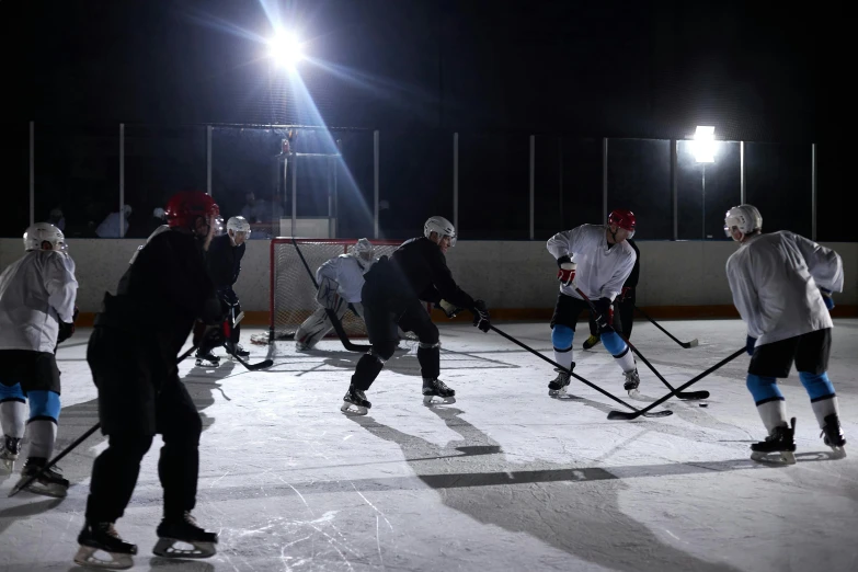 a group of people playing a game of ice hockey, reflective lighting, behind the scenes, no - text no - logo, shot on sony a 7