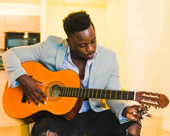 a man sitting on a chair playing a guitar, by Gavin Hamilton, pexels contest winner, romanticism, man is with black skin, 15081959 21121991 01012000 4k, instagram post, headshot
