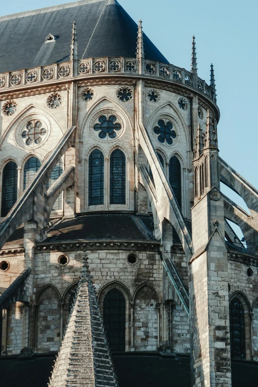 a very tall building with a clock on it's side, an album cover, by Theo Constanté, trending on unsplash, romanesque, huge support buttresses, normandy, dome, side view close up of a gaunt