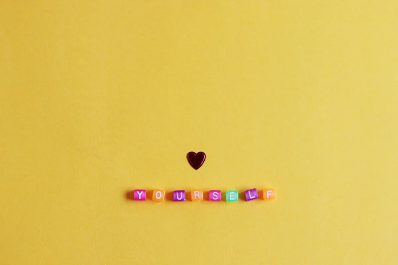 the word i love you spelled with beads on a yellow background, by Emma Andijewska, trending on pexels, aestheticism, candy, myself, flat minimalistic, lofi art