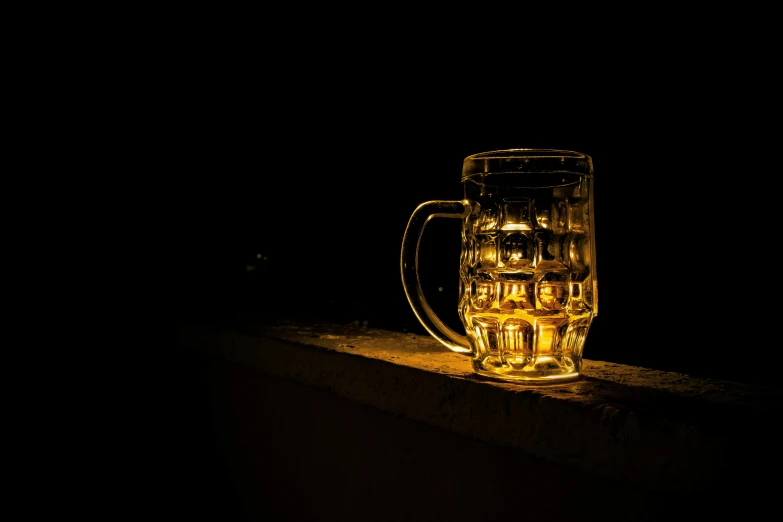 a glass of beer sitting on a ledge, a still life, by Adam Marczyński, pexels, photorealism, glowing in the dark, back - lit, night outside, gold