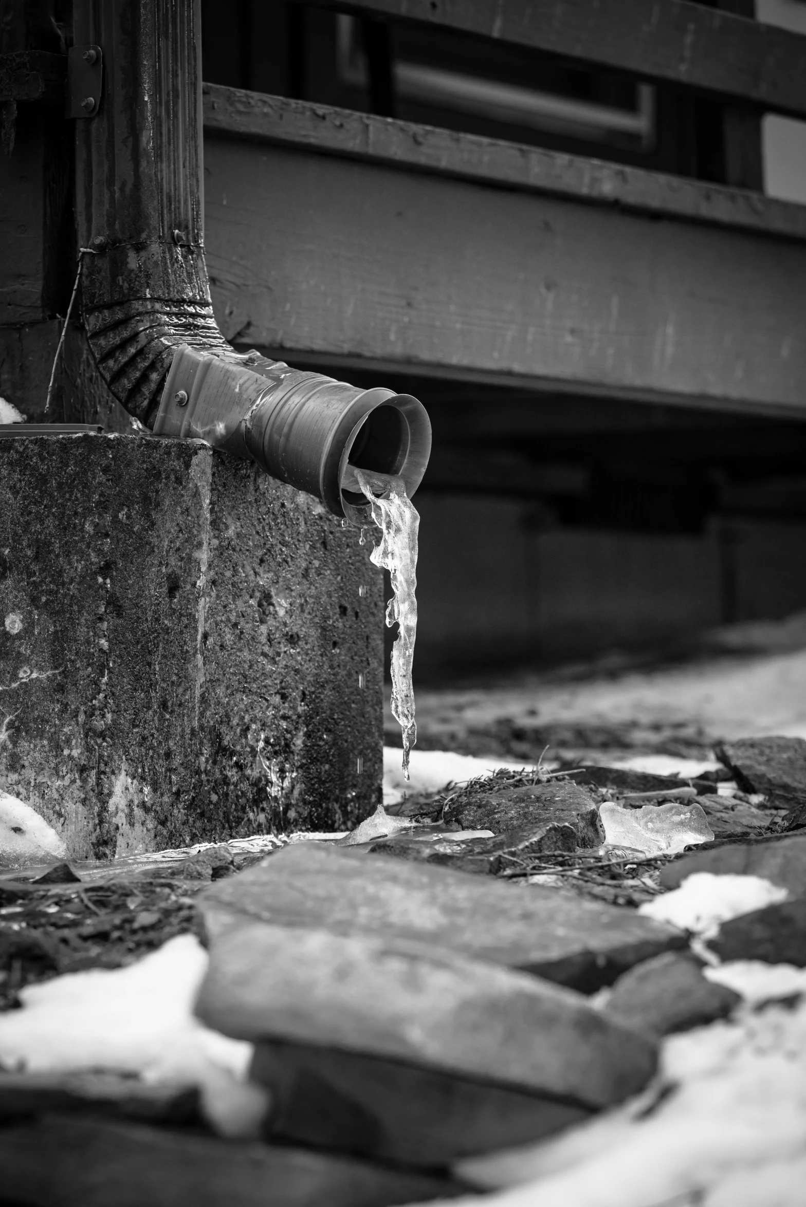 a black and white photo of a fire hydrant, a black and white photo, inspired by Louis Stettner, unsplash, plasticien, sitting under bridge, beer being drank and spilled, building crumbling, icicles