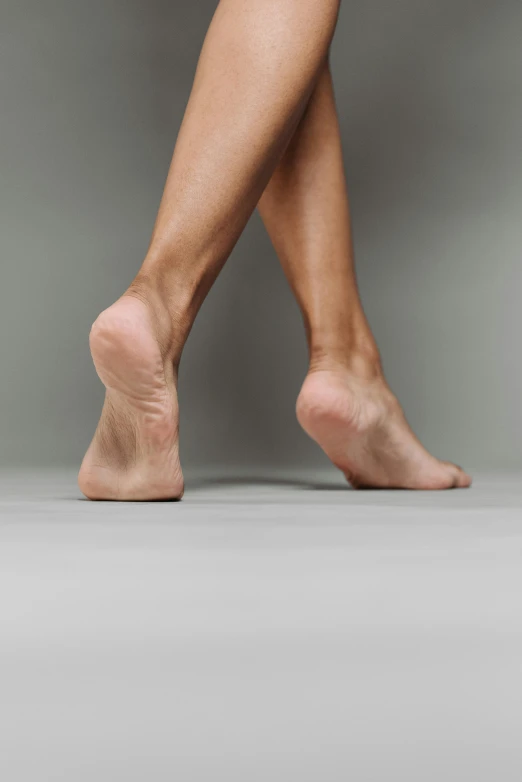 a close up of a person's bare legs, dynamics, from the side, grey, no - text no - logo