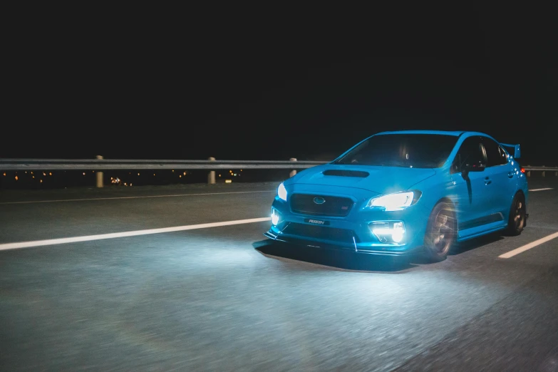 a blue car driving down a highway at night, a portrait, inspired by An Gyeon, unsplash, subaru, vray octane, f4”