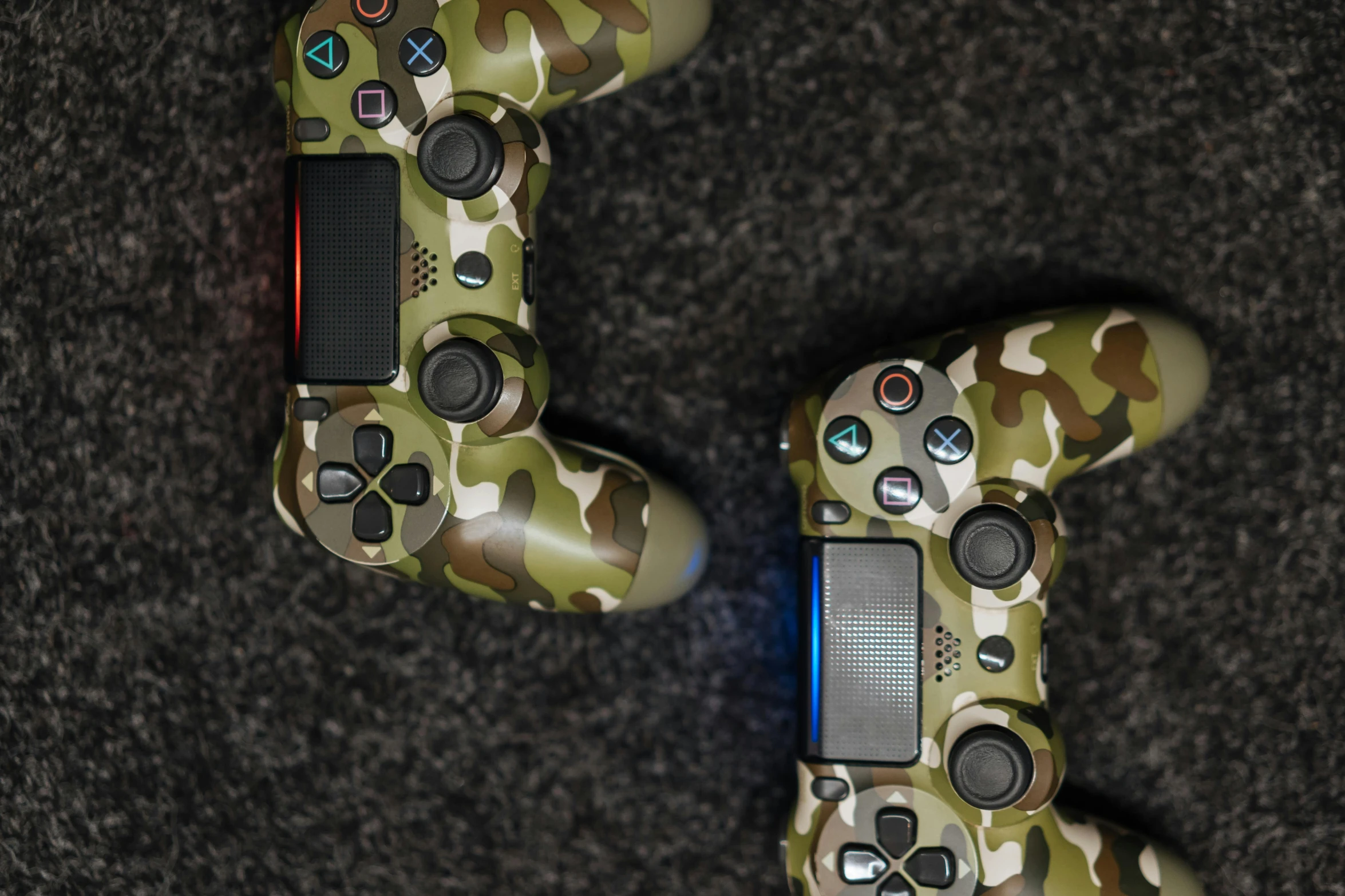 a couple of video game controllers sitting on top of a carpet, jungle camo, playstation 4, profile picture 1024px, 4 k ]