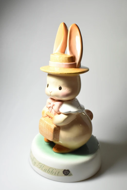 a figurine of a rabbit wearing a hat, by Tadashi Nakayama, with an easter basket, creamy, butter, music