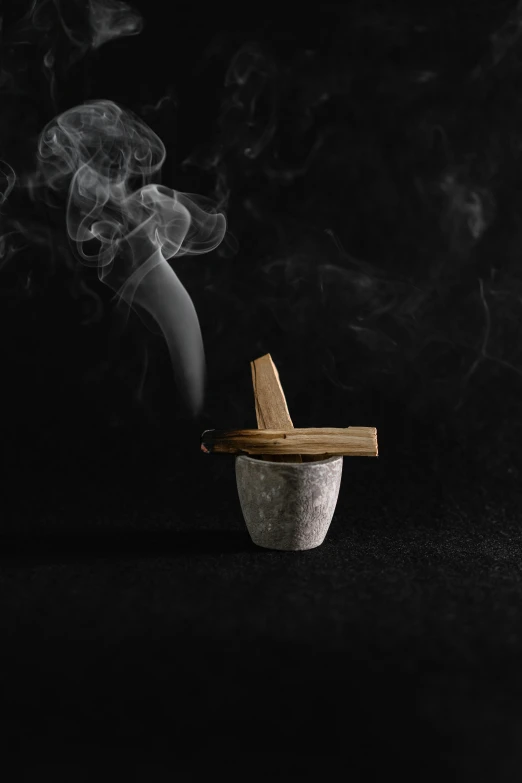 a mortar with a wooden stick sticking out of it, unsplash, conceptual art, gritty realistic smoke, deity), product design shot, grey