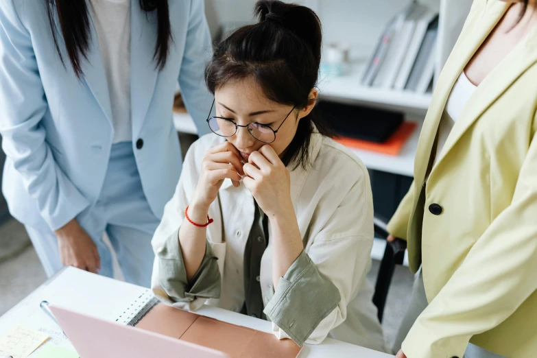 a woman sitting at a table in front of a laptop, by Jang Seung-eop, trending on pexels, people crying, standing in class, avatar image