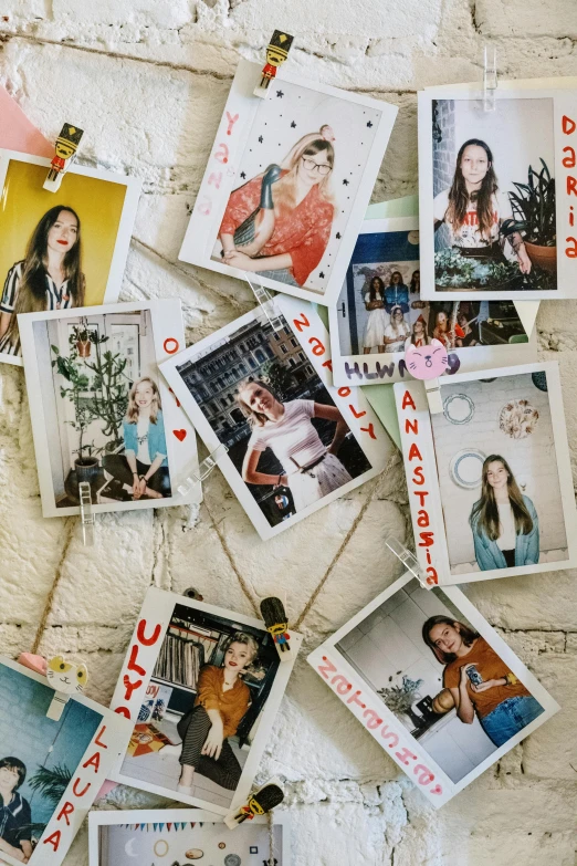 a bunch of pictures hanging on a brick wall, a polaroid photo, by Julia Pishtar, trending on pexels, portrait of anya taylor-joy, everyone having fun, magazine scraps, from waist up